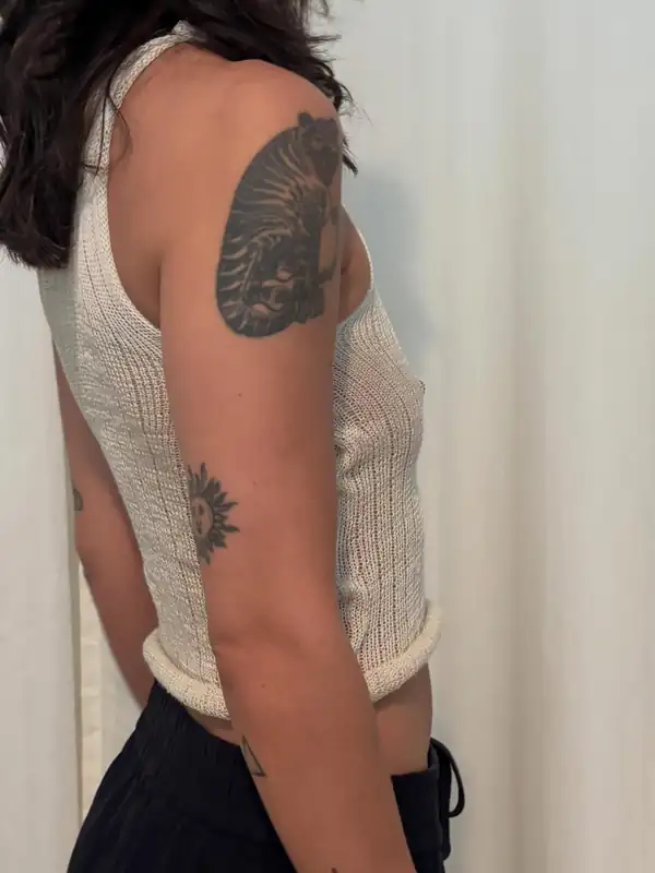 Side and back: the same top, showing the armhole and a large shoulder tattoo.