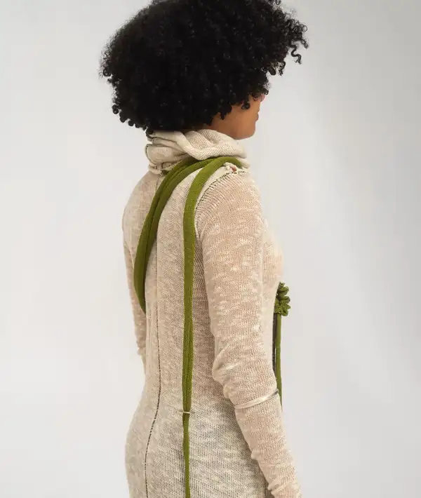 Back: the cowl neck of the dress and the bag strap crossing the shoulder.
