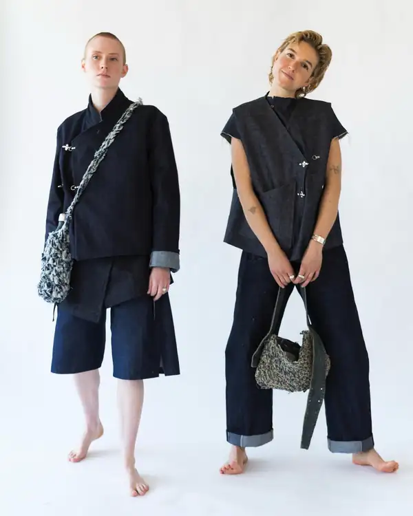 Two models standing: denim jacket with shorts, and denim vest with turned-up jeans, knitted bags.