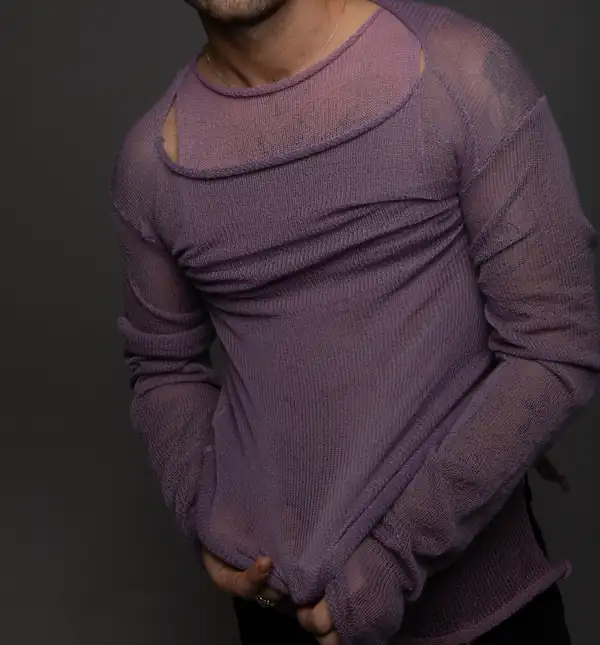 Layered: the lilac sleeveless over a lilac long-sleeve, hands in pockets.