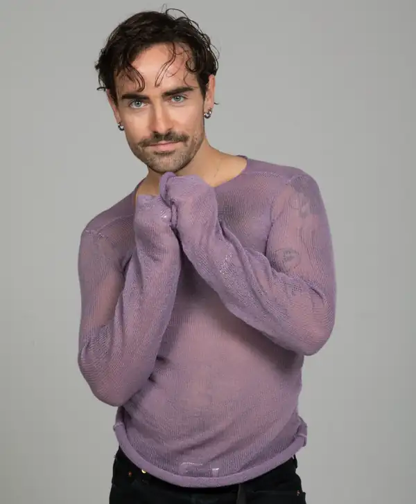 Hands to chin: the lilac sheer knit long-sleeve, showing full sleeve length.