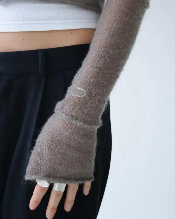 Close: the sleeve covering the hand to the knuckles.
