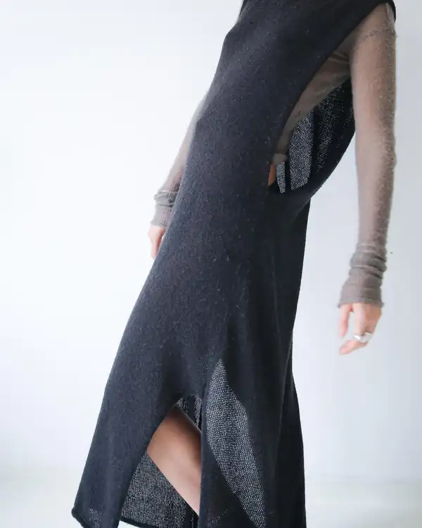 Close: the slit and side seam of the charcoal long dress.