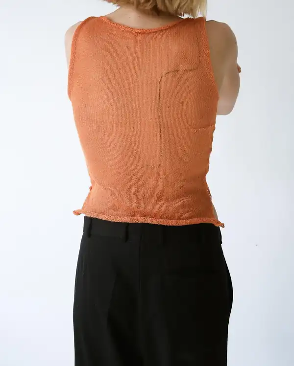 Back: the orange knit top showing a rear panel seam.
