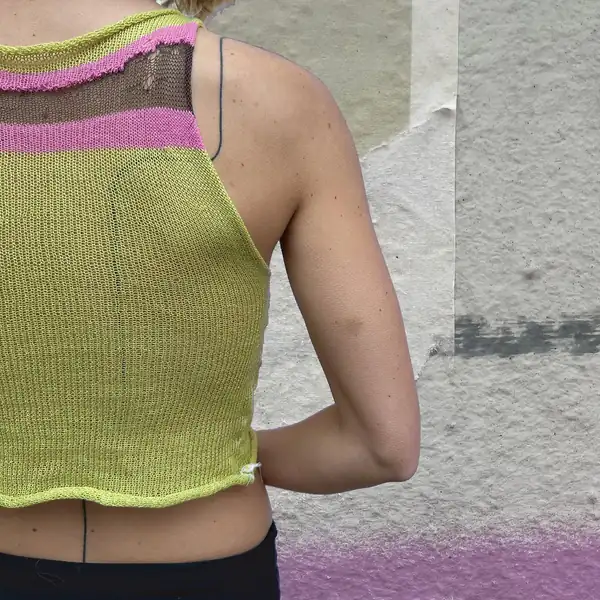 Back: the chartreuse top showing a pink and brown striped yoke with a sheer panel.
