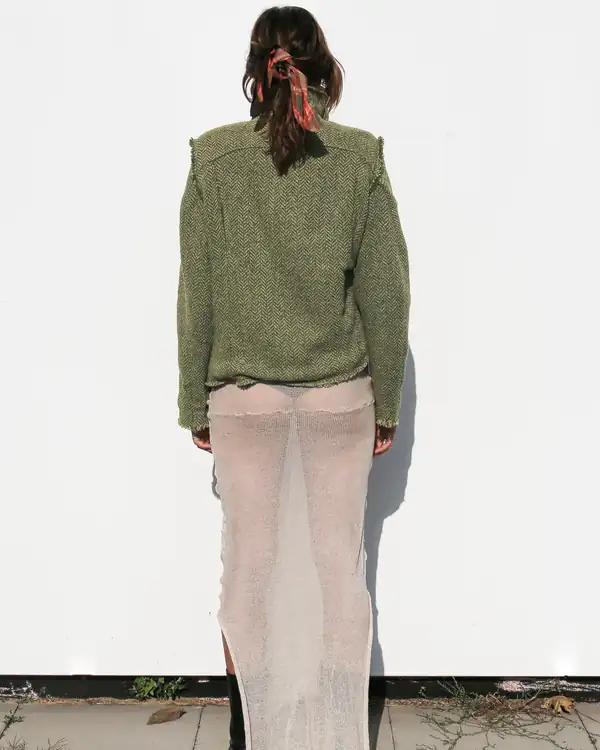 Back: the olive jacket's shoulder construction over the cream skirt.