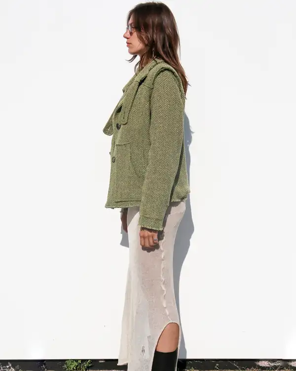 Side: the jacket's patch pockets, the cream skirt's slit.